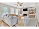 Inviting living room featuring a fireplace, built-in shelves, and an abundance of natural light at 3921 Upland Way, Marietta, GA 30066