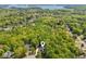 Property nestled among lush trees with water feature in the distance at 4750 Spring Wood Trce, Cumming, GA 30041