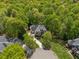 Aerial view of a two-story brick home nestled among lush trees in a suburban neighborhood at 4750 Spring Wood Trce, Cumming, GA 30041