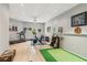 Finished basement with exercise equipment, golf putting green, and ample space for activities at 4750 Spring Wood Trce, Cumming, GA 30041