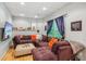 Cozy basement with a large sectional sofa, decorative pillows, and a mounted TV for entertainment at 4750 Spring Wood Trce, Cumming, GA 30041