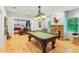 Spacious basement featuring a billiards table and separate seating area with stylish stone fireplace at 4750 Spring Wood Trce, Cumming, GA 30041