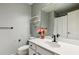 Clean bathroom with white vanity, decorative gold shelving, and fresh flowers for a bright, stylish touch at 4750 Spring Wood Trce, Cumming, GA 30041