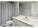 Bathroom with white counter, vanity, modern fixtures, and stylish dotted shower curtain at 4750 Spring Wood Trce, Cumming, GA 30041