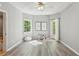 Bright, airy bedroom with light gray walls, a ceiling fan, and access to the outside at 4750 Spring Wood Trce, Cumming, GA 30041
