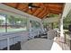 Inviting clubhouse with wood ceilings, ceiling fans, and screened windows overlooking sports courts at 4750 Spring Wood Trce, Cumming, GA 30041