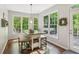 Bright dining area with large windows, hardwood floors, and access to the outdoor deck at 4750 Spring Wood Trce, Cumming, GA 30041