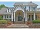 Traditional two-story home with a covered porch, manicured landscaping, and inviting curb appeal at 4750 Spring Wood Trce, Cumming, GA 30041