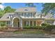 Beautiful traditional two-story home with charming curb appeal, a covered porch, and mature landscaping at 4750 Spring Wood Trce, Cumming, GA 30041