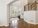 Light-filled foyer featuring hardwood floors, staircase and front door with glass inserts at 4750 Spring Wood Trce, Cumming, GA 30041