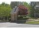 Stone guardhouse with manicured landscaping and a charming cupola adds security and curb appeal to the neighborhood at 4750 Spring Wood Trce, Cumming, GA 30041