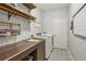 Well-organized laundry room with shelving, patterned flooring, and modern washer and dryer at 4750 Spring Wood Trce, Cumming, GA 30041