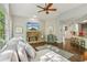 Spacious living room featuring a stone fireplace, large windows and an open layout flowing into the kitchen at 4750 Spring Wood Trce, Cumming, GA 30041
