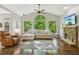 Living room with vaulted ceiling, large windows offering wooded view, and stone fireplace at 4750 Spring Wood Trce, Cumming, GA 30041