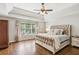 Serene main bedroom with tray ceilings, hardwood floors, and large windows at 4750 Spring Wood Trce, Cumming, GA 30041