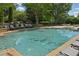 Community pool featuring poolside seating and natural surroundings at 4750 Spring Wood Trce, Cumming, GA 30041