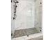 Luxurious walk-in shower with white marble tiling and black hardware at 4750 Spring Wood Trce, Cumming, GA 30041