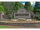 Stone sign for the Chattahoochee River Club community with lush landscaping and stone accents at 4750 Spring Wood Trce, Cumming, GA 30041
