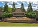 Chattahoochee River Club stone sign with mature trees and landscaping for a welcoming entrance at 4750 Spring Wood Trce, Cumming, GA 30041