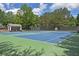 Well-maintained blue tennis courts and clubhouse surrounded by lush greenery at 4750 Spring Wood Trce, Cumming, GA 30041