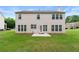 Spacious backyard featuring a large well-maintained lawn, patio, and rear elevation at 550 Bayswater Way, Suwanee, GA 30024