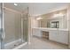 Bathroom featuring double vanity, soaking tub, and glass-enclosed shower at 550 Bayswater Way, Suwanee, GA 30024