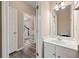 Half bathroom with white vanity and mirror at 550 Bayswater Way, Suwanee, GA 30024