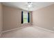 Bedroom with plush carpeting and blue curtains at 550 Bayswater Way, Suwanee, GA 30024