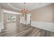 Spacious dining room with wood flooring, large windows and decorative chandelier at 550 Bayswater Way, Suwanee, GA 30024
