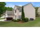 Charming home with a two-car garage and meticulously manicured lawn, enhanced by vibrant landscaping at 550 Bayswater Way, Suwanee, GA 30024