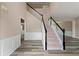 Spacious foyer featuring wood flooring, staircase with white railing and high ceiling at 550 Bayswater Way, Suwanee, GA 30024