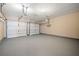 Spacious two car garage featuring automatic door openers and sealed concrete floors at 550 Bayswater Way, Suwanee, GA 30024