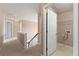 Upstairs hallway with a laundry room visible through an open door at 550 Bayswater Way, Suwanee, GA 30024