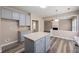 Kitchen island with wood flooring and a partial view of the adjacent Gathering room at 550 Bayswater Way, Suwanee, GA 30024