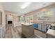 Open kitchen with wood flooring, an island and stainless steel appliances at 550 Bayswater Way, Suwanee, GA 30024
