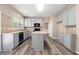 Updated kitchen features stainless appliances, an island and light gray cabinets at 550 Bayswater Way, Suwanee, GA 30024