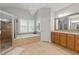 Bathroom showcasing dual sink vanity, a shower, and a soaking tub beneath a chandelier at 3883 Wakefield Hall Se Sq, Smyrna, GA 30080