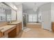 Bathroom featuring dual sink vanity, a shower, a soaking tub, and neutral tile flooring at 3883 Wakefield Hall Se Sq, Smyrna, GA 30080