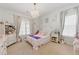 Charming bedroom features a chandelier, bright windows, and elegant furnishings creating a cozy and inviting space at 3883 Wakefield Hall Se Sq, Smyrna, GA 30080