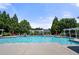 Community pool surrounded by mature trees, lounge chairs, and patio furniture at 3883 Wakefield Hall Se Sq, Smyrna, GA 30080