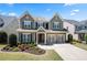 Charming two-story home with a well-manicured lawn and a two-car garage, creating a welcoming curb appeal at 3883 Wakefield Hall Se Sq, Smyrna, GA 30080