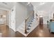 Open foyer with hardwood floors, staircase, and elegant decor creates a grand entrance with lots of light at 3883 Wakefield Hall Se Sq, Smyrna, GA 30080