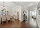 Elegant hallway and formal dining room featuring hardwood floors and decorative molding, creating a sophisticated ambiance at 3883 Wakefield Hall Se Sq, Smyrna, GA 30080