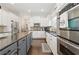 Bright kitchen featuring white cabinets, gray island, stainless steel appliances, and hardwood floors at 3883 Wakefield Hall Se Sq, Smyrna, GA 30080