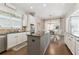 Spacious kitchen features a central island and seamless connection to a dining area filled with natural light at 3883 Wakefield Hall Se Sq, Smyrna, GA 30080