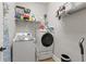 Laundry room equipped with modern washer and dryer, shelving, and neutral tile flooring at 3883 Wakefield Hall Se Sq, Smyrna, GA 30080