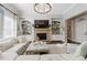 Comfortable living room with a stone fireplace, built-in shelving, and a large sectional, perfect for relaxation at 3883 Wakefield Hall Se Sq, Smyrna, GA 30080