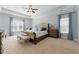 Bright main bedroom with tray ceiling, carpet, and ample natural light at 3883 Wakefield Hall Se Sq, Smyrna, GA 30080