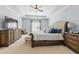 Spacious main bedroom with sitting area, dresser, and tufted headboard at 3883 Wakefield Hall Se Sq, Smyrna, GA 30080