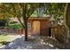 Exterior view of a wooden backyard storage shed with a large sliding barn door on a deck at 3883 Wakefield Hall Se Sq, Smyrna, GA 30080